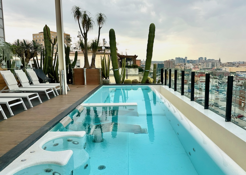 Rooftop pool with hydrotherapy jets and sun loungers on the terrace at Romeo Hotel in Naples, Italy