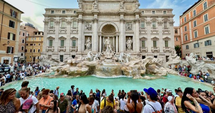 Tourists sightseeing at Trevi Fountain in Rome.