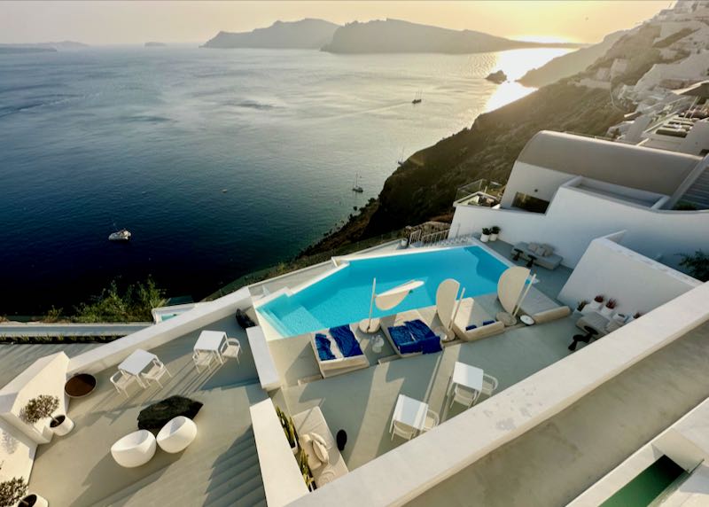 Hotel in Oia, Santorini with sunset and caldera view.