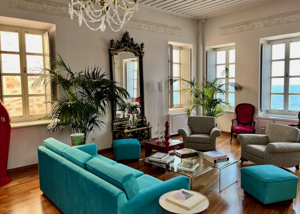 Elegant sitting room with chandelier and velvet furnishings
