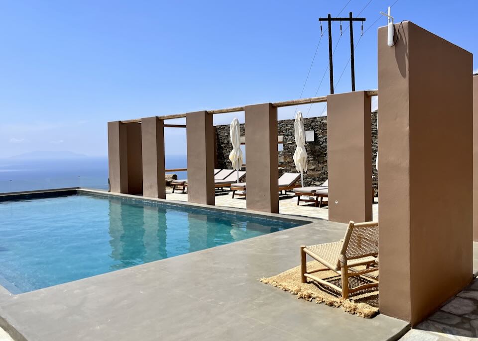 Pool terrace with cabanas overlooking the blue sea