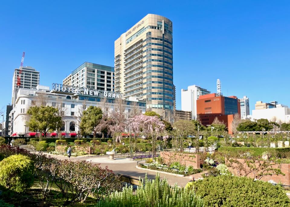 A flourishing garden sits in front of a hotel.