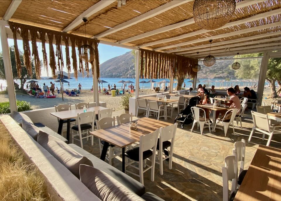 Covered restaurant patio overlooking a sandy beach