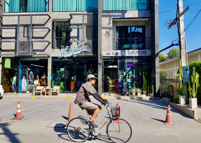 A man rides a bike through the city.