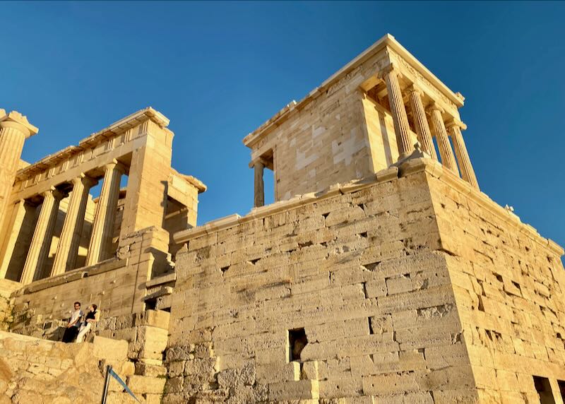 Photo looking up at the Temple of Athena Nike on the Athens Acropolis on a sunny day