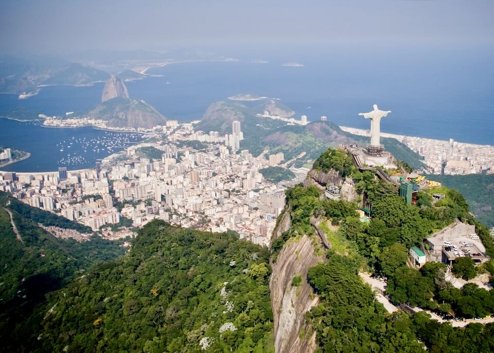 Aerial view of Rio de Janeiro from behind and over the Christ the Redeemer statue.