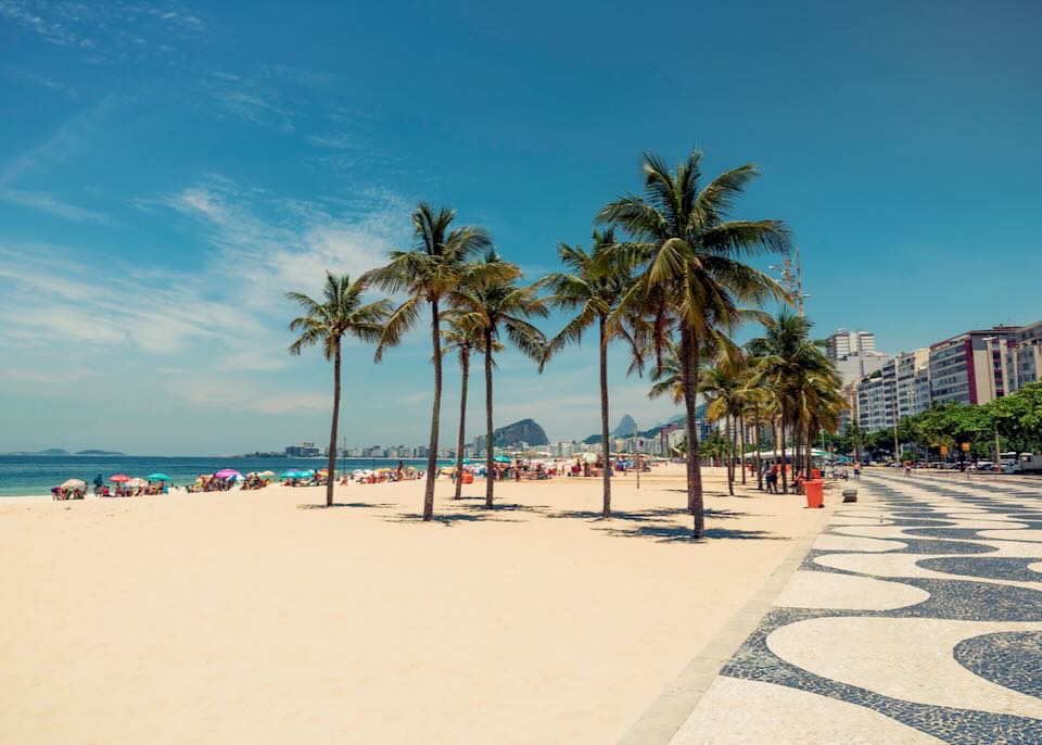 View of sandy Copacabana beach from the stone mosaic promenade.