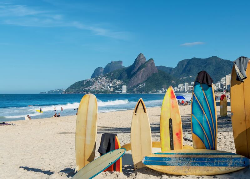 Amazing view of Ipanema Beach, with colorful surfboards standing on a line on the sand