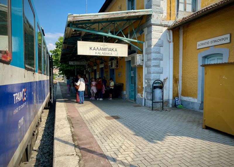 Train platform with overhead signage reading "Kalambaka"
