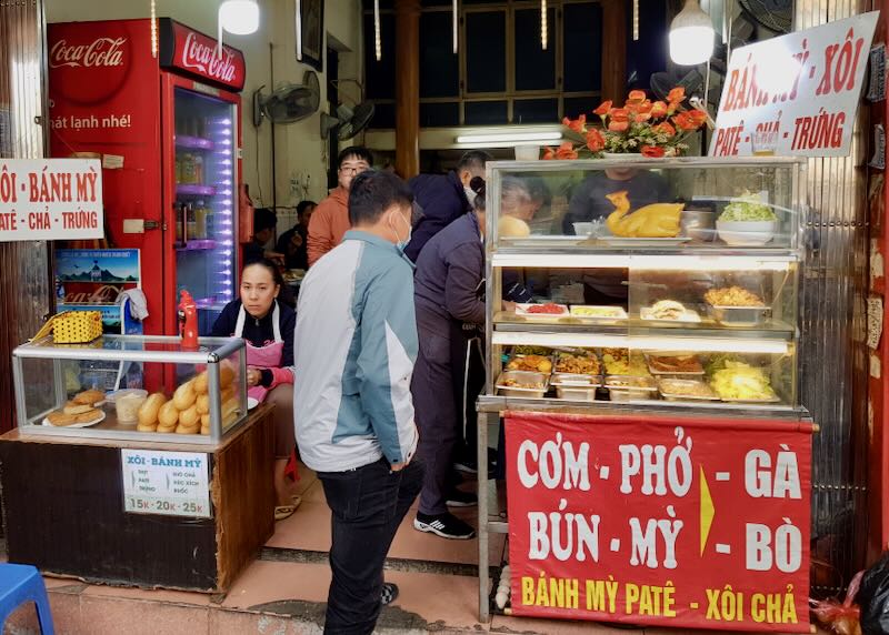 A small food stall sells pho.