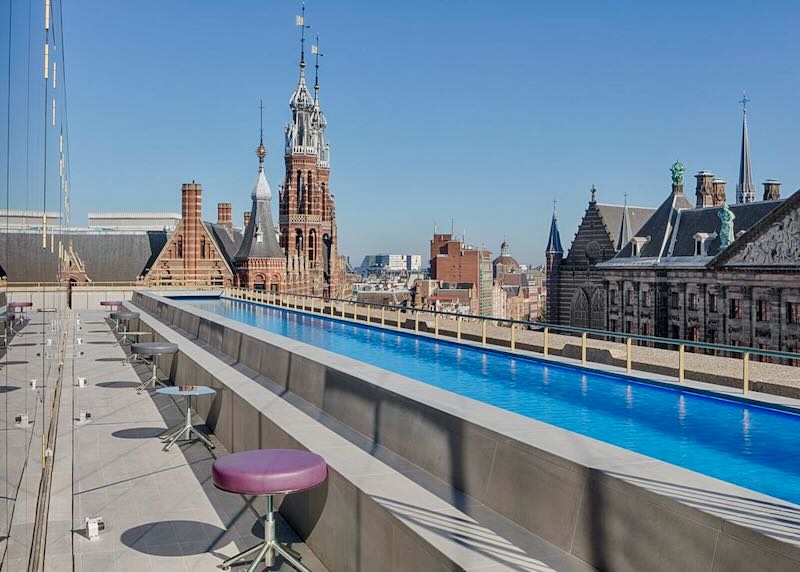 Long blue rooftop swimming pool with views over Amsterdam.