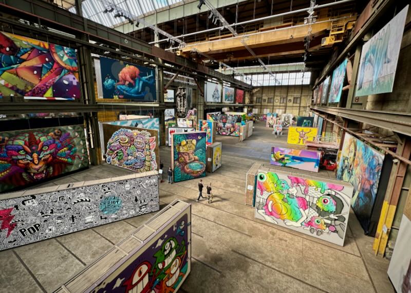 Warehouse-like museum space filled with graffiti murals