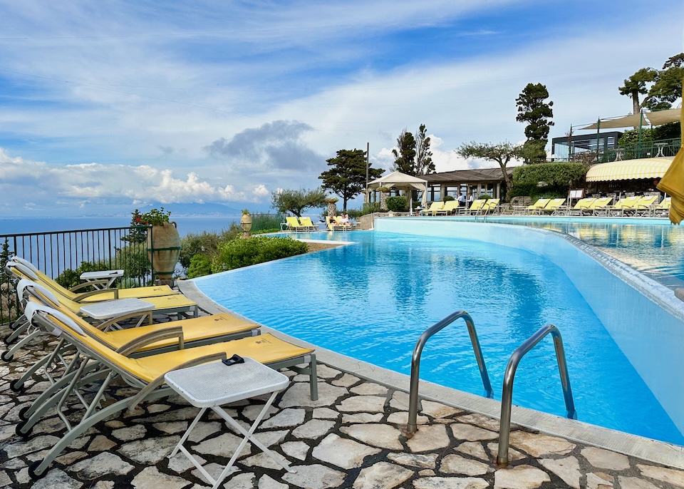 Two-tiered infinity pool with ringed with sunbeds overlooking the sea at Hotel Caesar Augustus in Capri