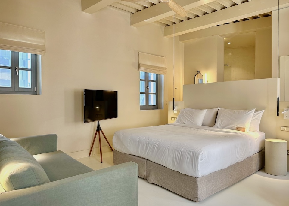 Minimalist room style with high ceilings and exposed rafters at Azade hotel in Crete