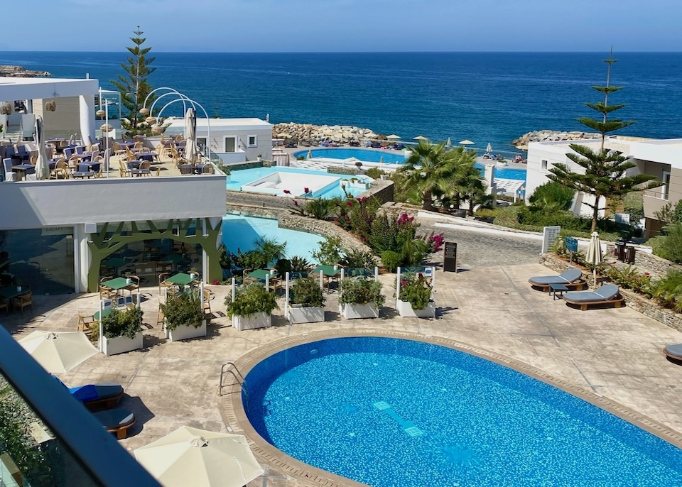 A series of different shaped pools in front of the sea at Royal Blue resort in Crete