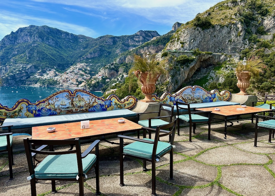 Terrace with maiolica-tile benches and views over the sea to Positano from Il San Pietro hotel