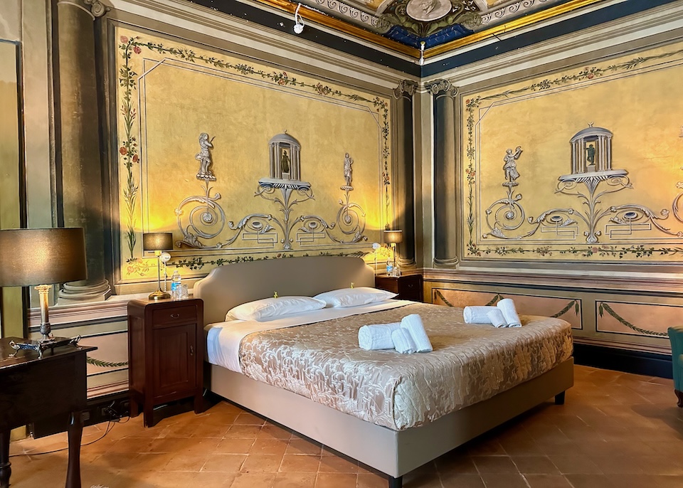 Vibrant frescoed walls and ceiling in a suite at Casa Santangelo in Salerno
