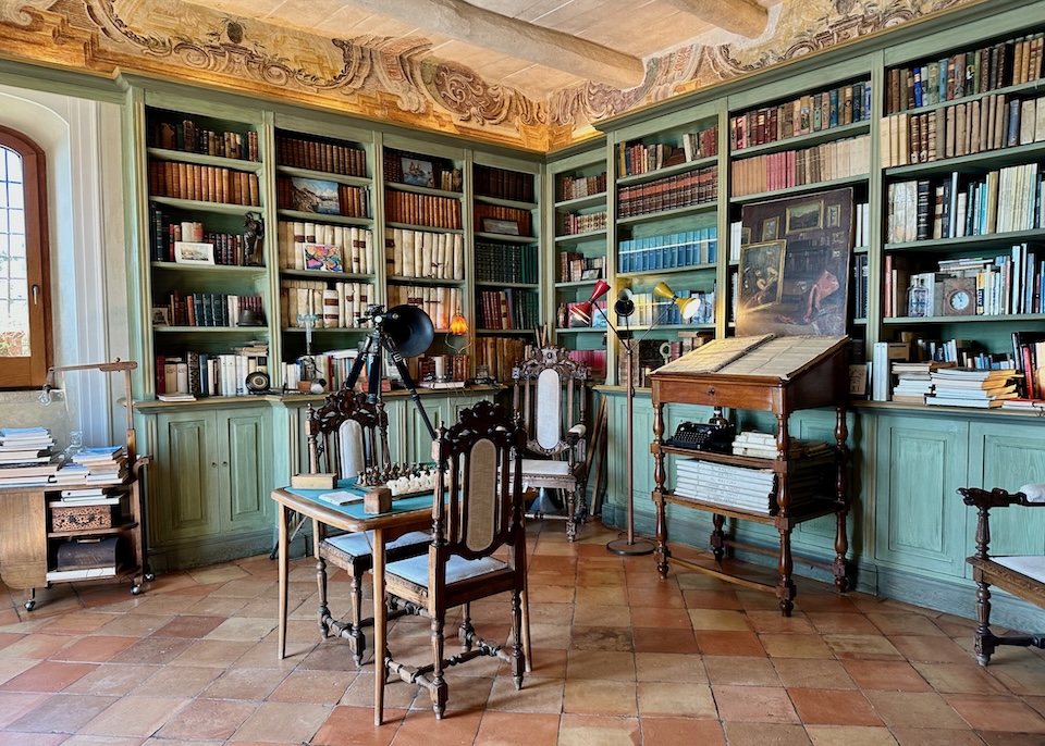 Library at Palazzo Suriano hotel in Vietri sul Mare with antique furniture, frescoes, and terracotta tile floors