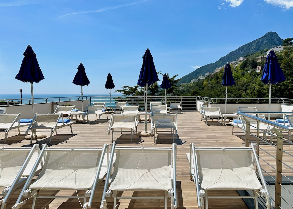 The sun terrace at Relais Paradiso hotel in Vietri sul Mare with the mountains and sea in the distance