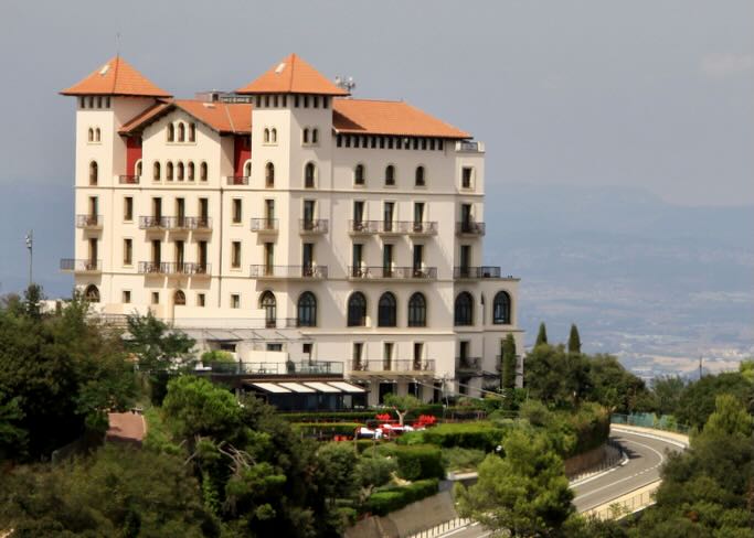 Large castle-like hotel on a hill overlooking Barcelona.