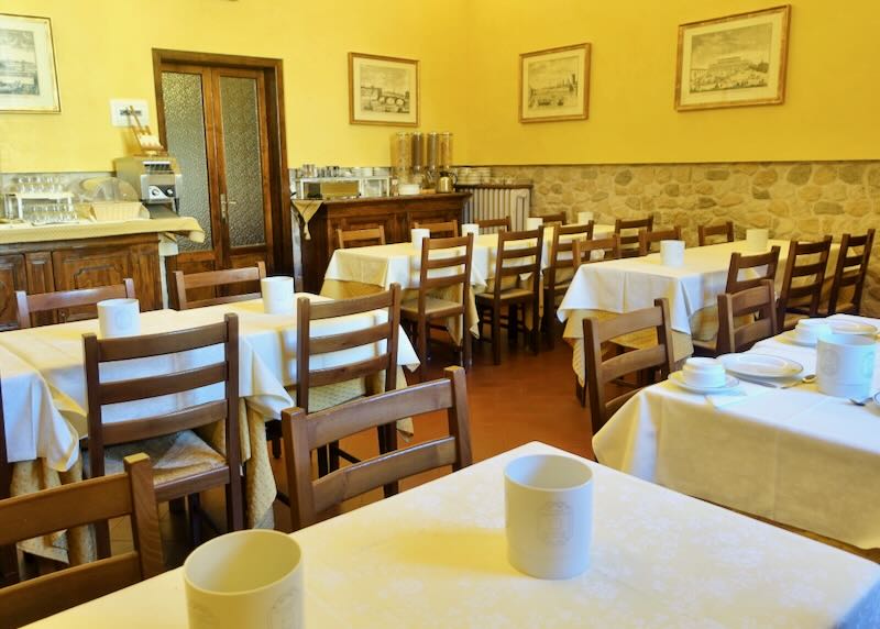 Breakfast room in an Italian hotel set for service. 