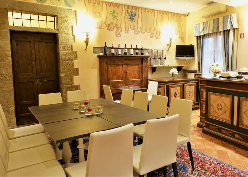 Rustic breakfast room in an Italian hotel with wooden tables and leather chairs