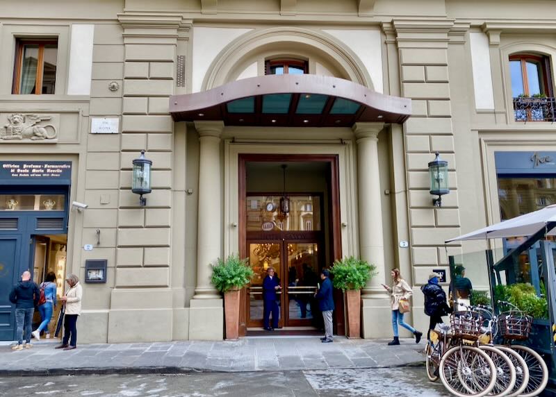 Italian hotel entrance with bicycles parked outside.