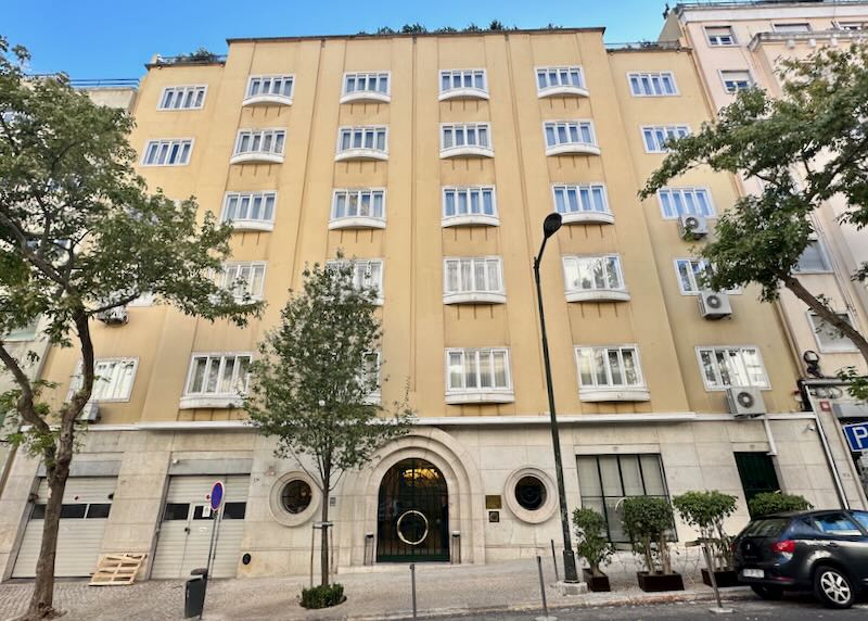 Exterior of a cream-colored art deco-inspired hotel in Lisbon