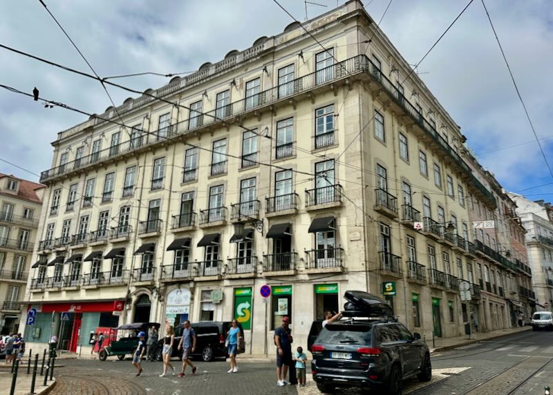 Corner view of a traditional style hotel on a busy Lisbon intersection