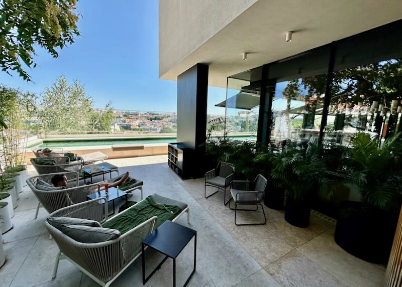 Swim terrace with lounge chairs at a modern hotel 