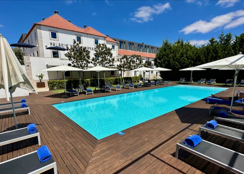 Outdoor pool deck surrounded by lounge chairs at a historic Lisbon hotel