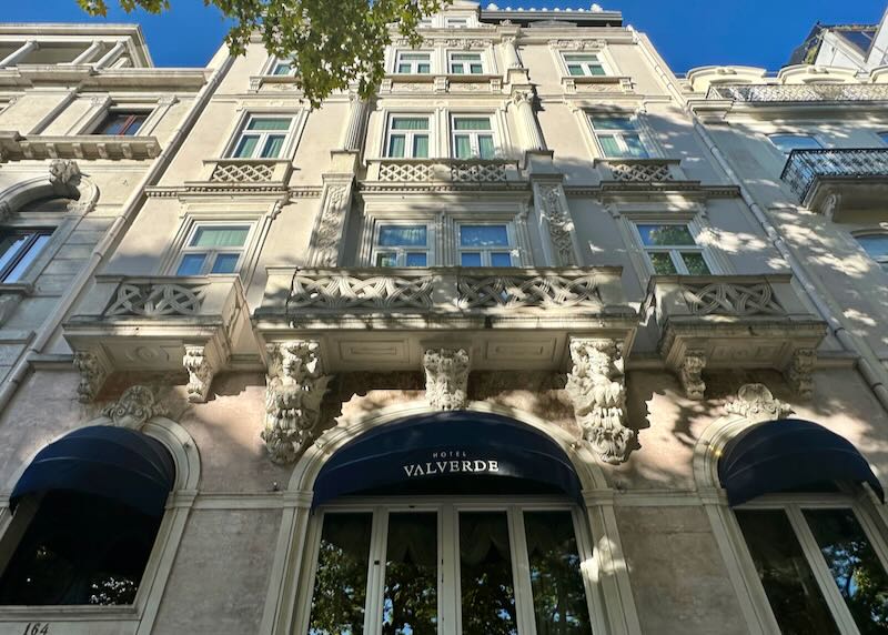 View looking up at the ornate stone facade of a luxury hotel in Lisbon