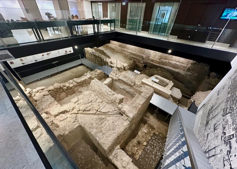 Archeological excavation in a hotel lobby, with viewing areas above