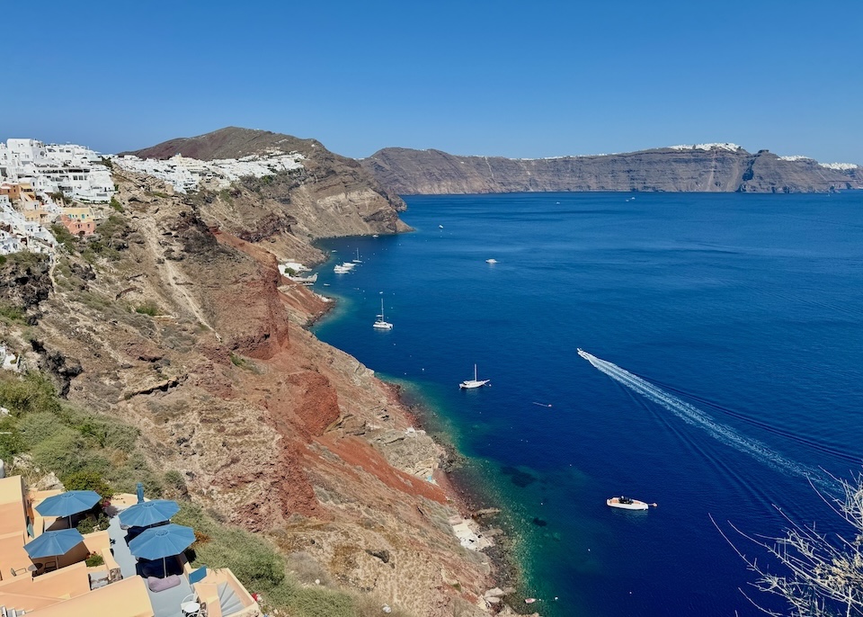 View of Oia village and the caldera facing three more clifftop villages in the background in Santorini