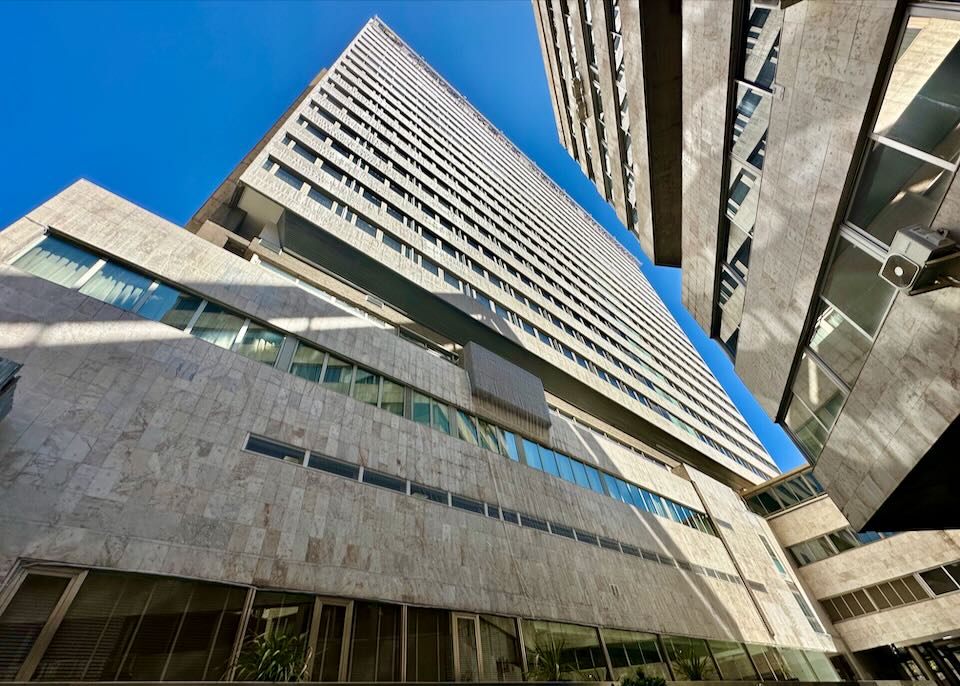 Angular and modern high-rise hotel, viewed from below.