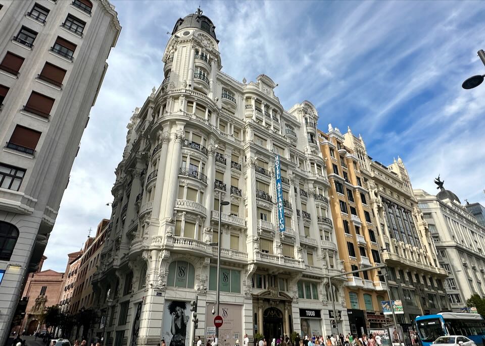 Stately white hotel on a busy corner in Madrid.