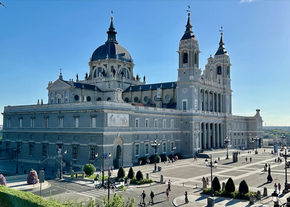 Photograph of the Royal Palace in Madrid on a sunny day, shot from a distance.