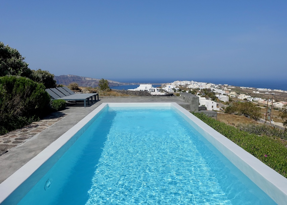 A large private pool facing west toward Oia, the caldera, and the sea in the distance at 270 Oia's View in Santorini.