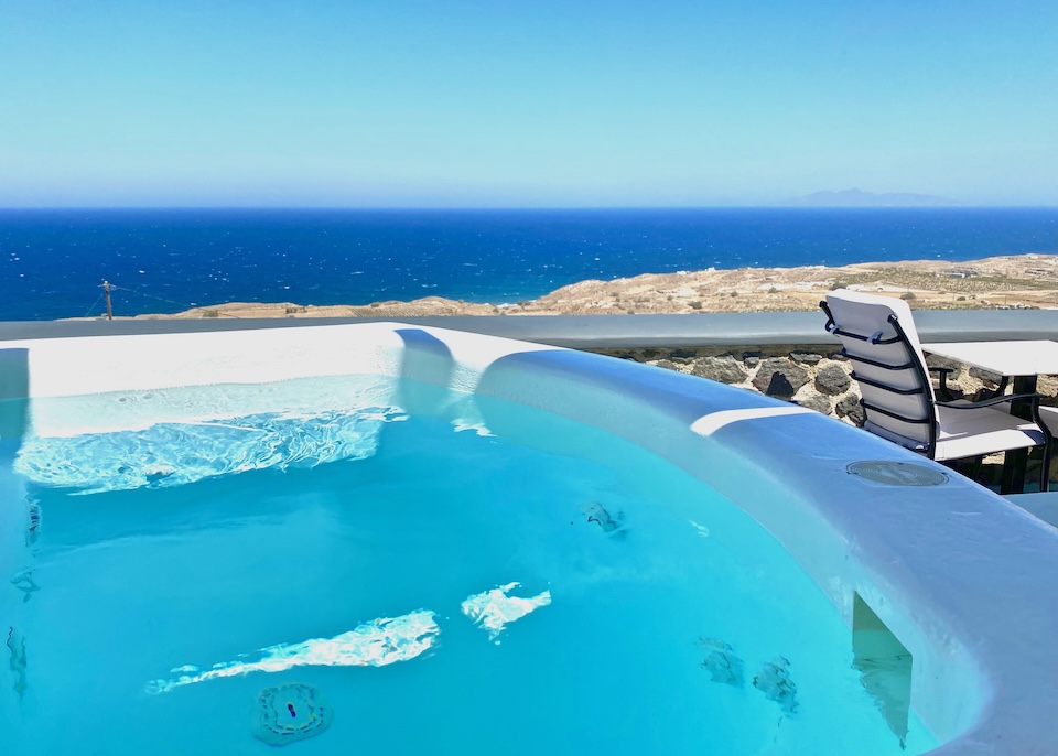 A whitewashed private jacuzzi facing east toward the sea at Amber Light hotel in Imerovigli, Santorini.