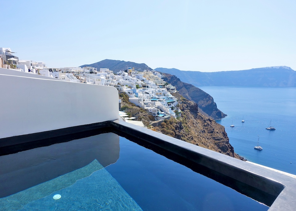 An infinity plunge pool overlooking the caldera and village at Andronis Luxury Suites in Oia, Santorini