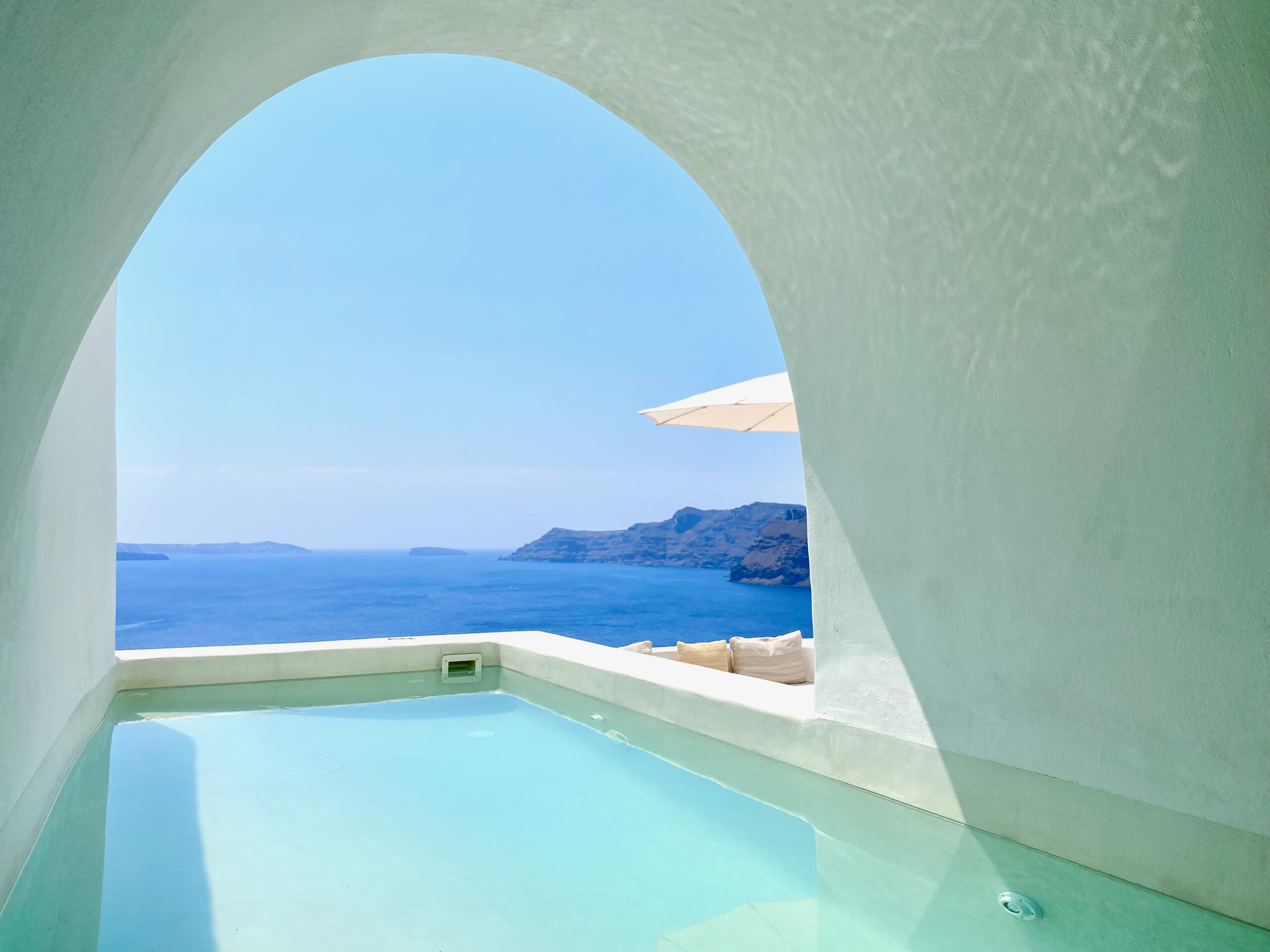 Inside a partially covered cave pool next to its private terrace above the caldera at Armenaki Suites in Oia, Santorini.