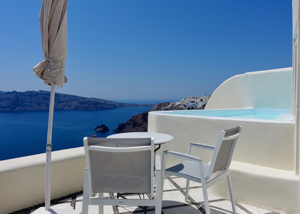 A private plunge pool on a sunny terrace overlooking the caldera at Canaves Suites in Oia, Santorini.