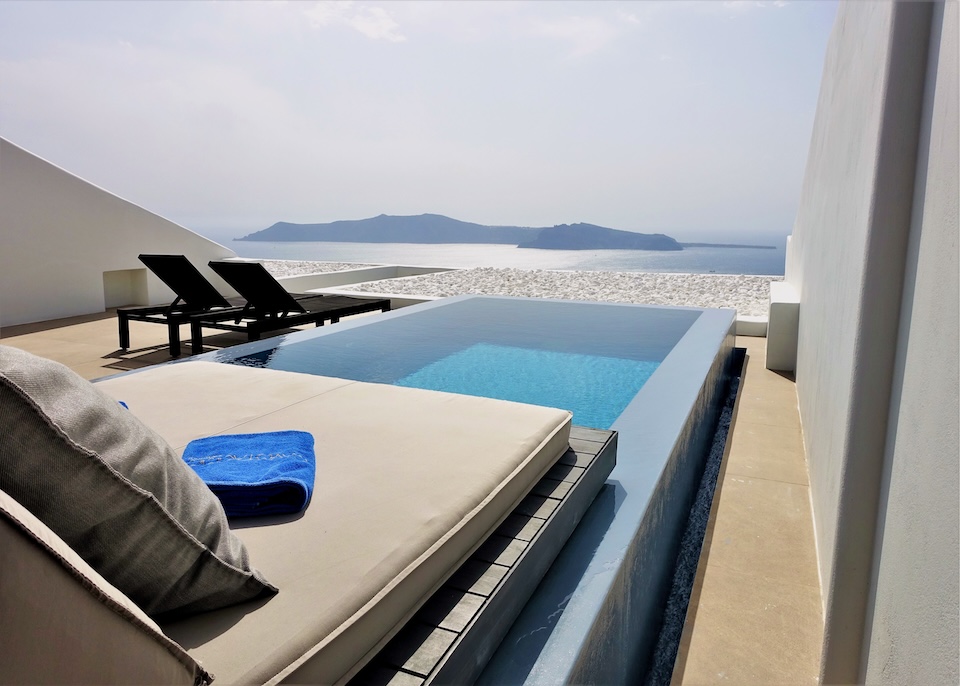 A private plunge pool on a spacious, furnished terrace above the caldera at Cavo Tagoo in Imerovigli, Santorini.