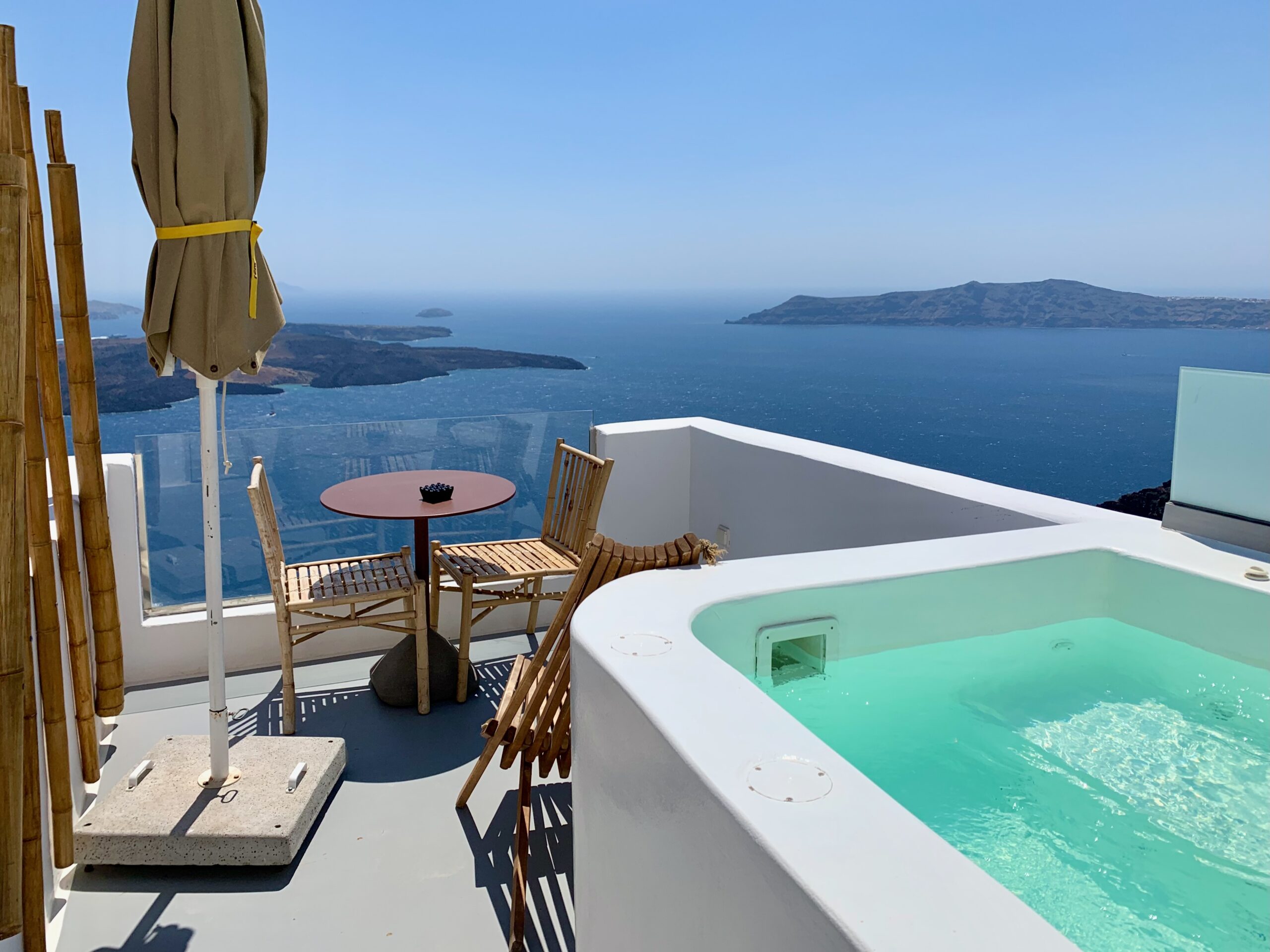 A private plunge pool on a furnished balcony facing the volcano and caldera at Cocoon Suites in Imerovigli, Santorini.