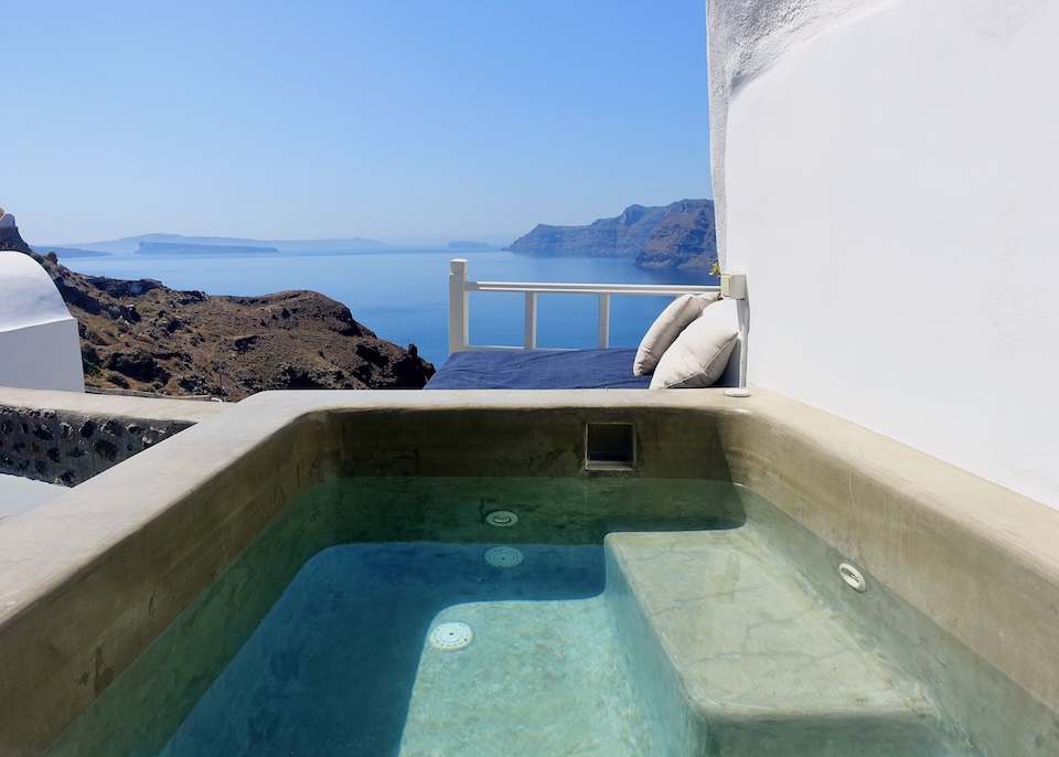 A private jacuzzi behind a sunbed above the caldera at Esperas Suites in Oia, Santorini