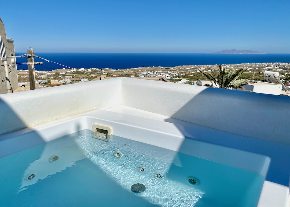 A private jacuzzi facing toward the Aegean Sea in the distance at Eternity Suites in Fira, Santorini.