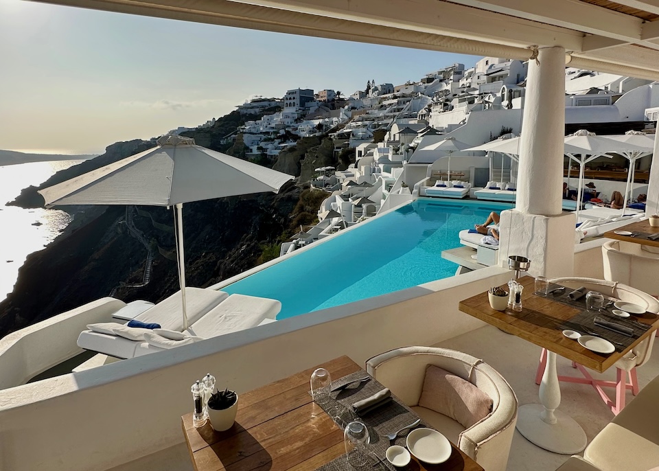 View of the pool and caldera from the restaurant at Katikies Hotel in Oia, Santorini.