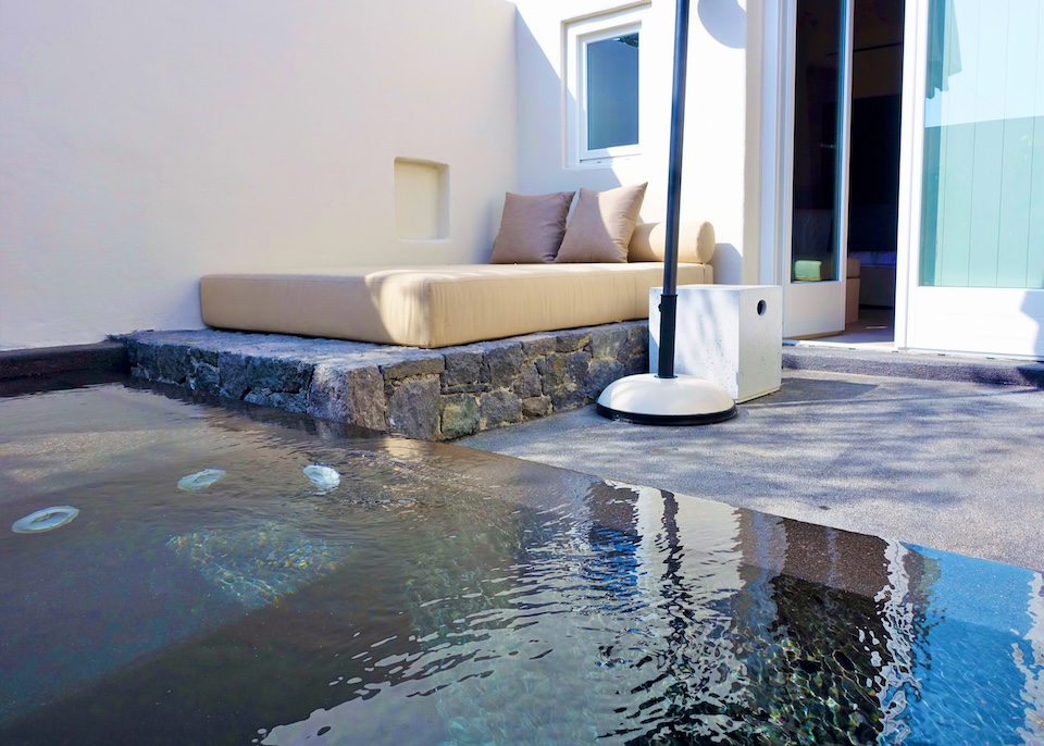 A sleek black private pool on the patio behind a suite at Istoria Hotel in Perivolos, Santorini.