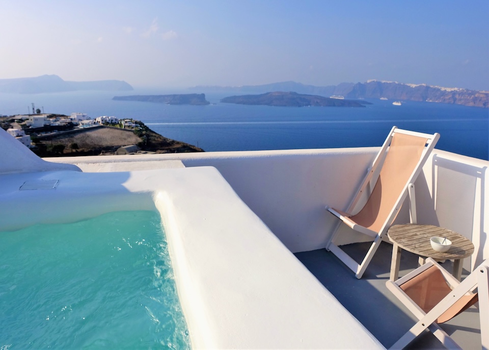 A rooftop plunge pool with caldera views toward the volcanoes at Kalestesia Suites in Aklrotiri, Santorini.