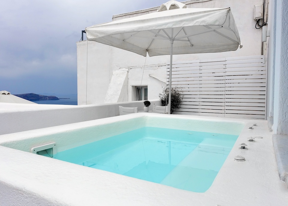 A private jacuzzi with a partial caldera view on a terrace at Kamares Apartments in Fira, Santorini